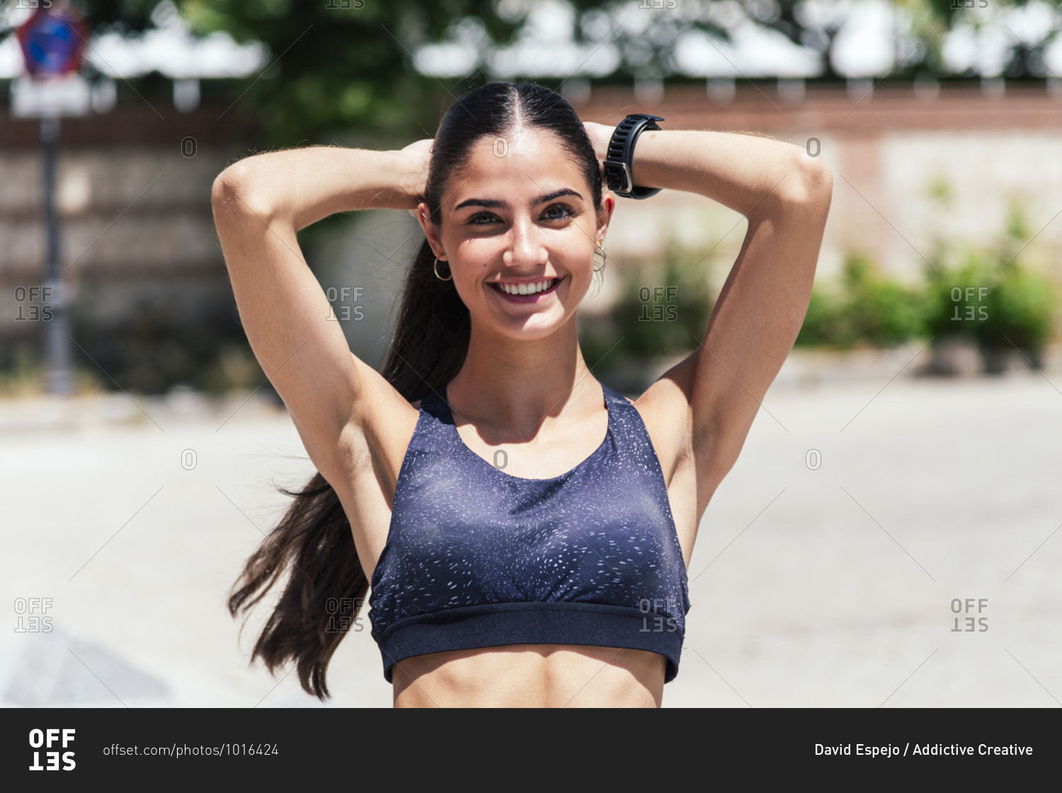 LS Female fair hair tied into chignon, wearing a sports bra top