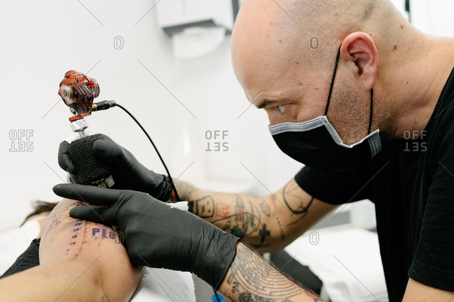 Tattooist With His Machine Tattooing On The Arm With The Design Drawn  Concept Of Art And Design Stock Photo Picture And Royalty Free Image  Image 149668160