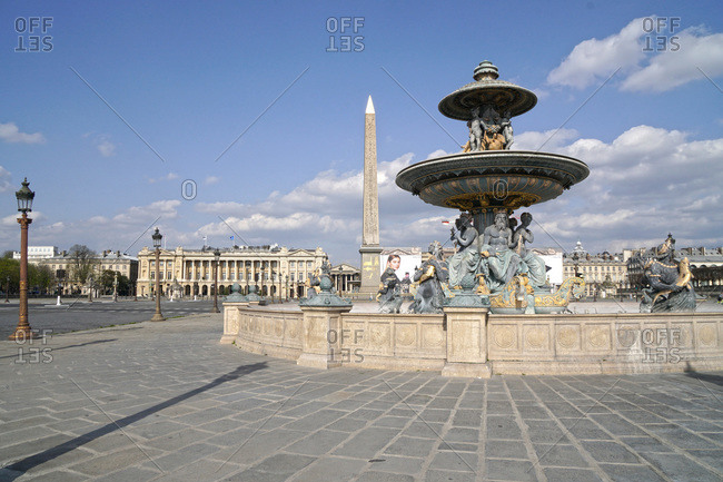 France - March 19,  2020: France Paris,  8th arrondissement 20/03/20. No traffic on empty Place de la Concorde,  due to the containment obligation decided by the French Government to fight the epidemic. "Fontaine des mers" in foreground.