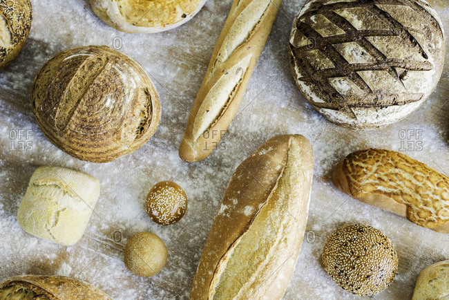 Large variety of wholemeal and white bread rolls and loaves, overhead view