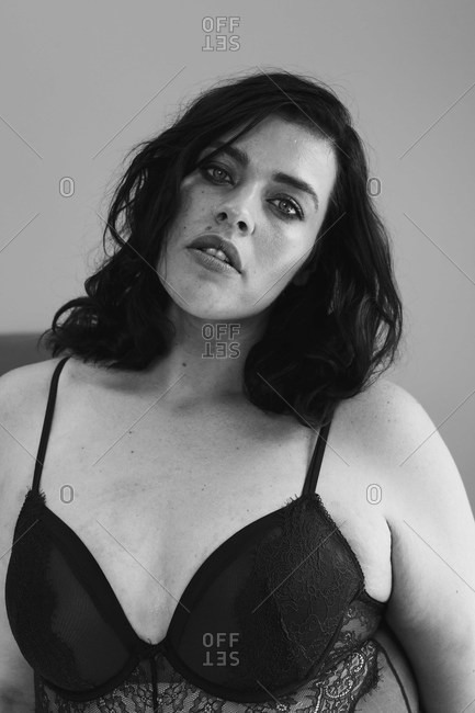 Woman in lingerie posing in bedroom