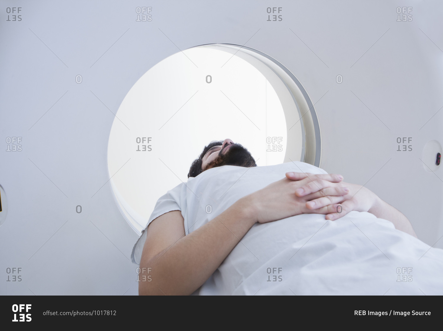 Young male patient having a CT scan in radiology department