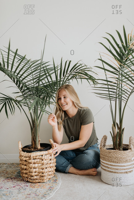 Woman admiring her house plant