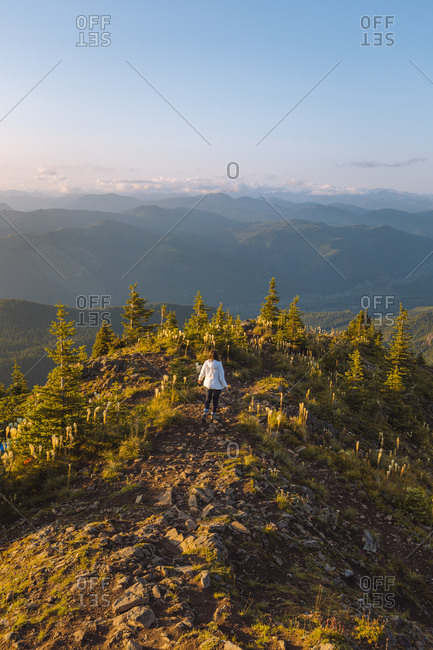 Female hiker enjoying view on peak, Kelly Butte Lookout Tower, Mt Rainier National Park, Washington, USA