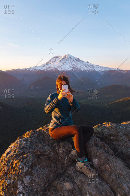 Female hiker taking selfie on peak, Mount Rainier National Park