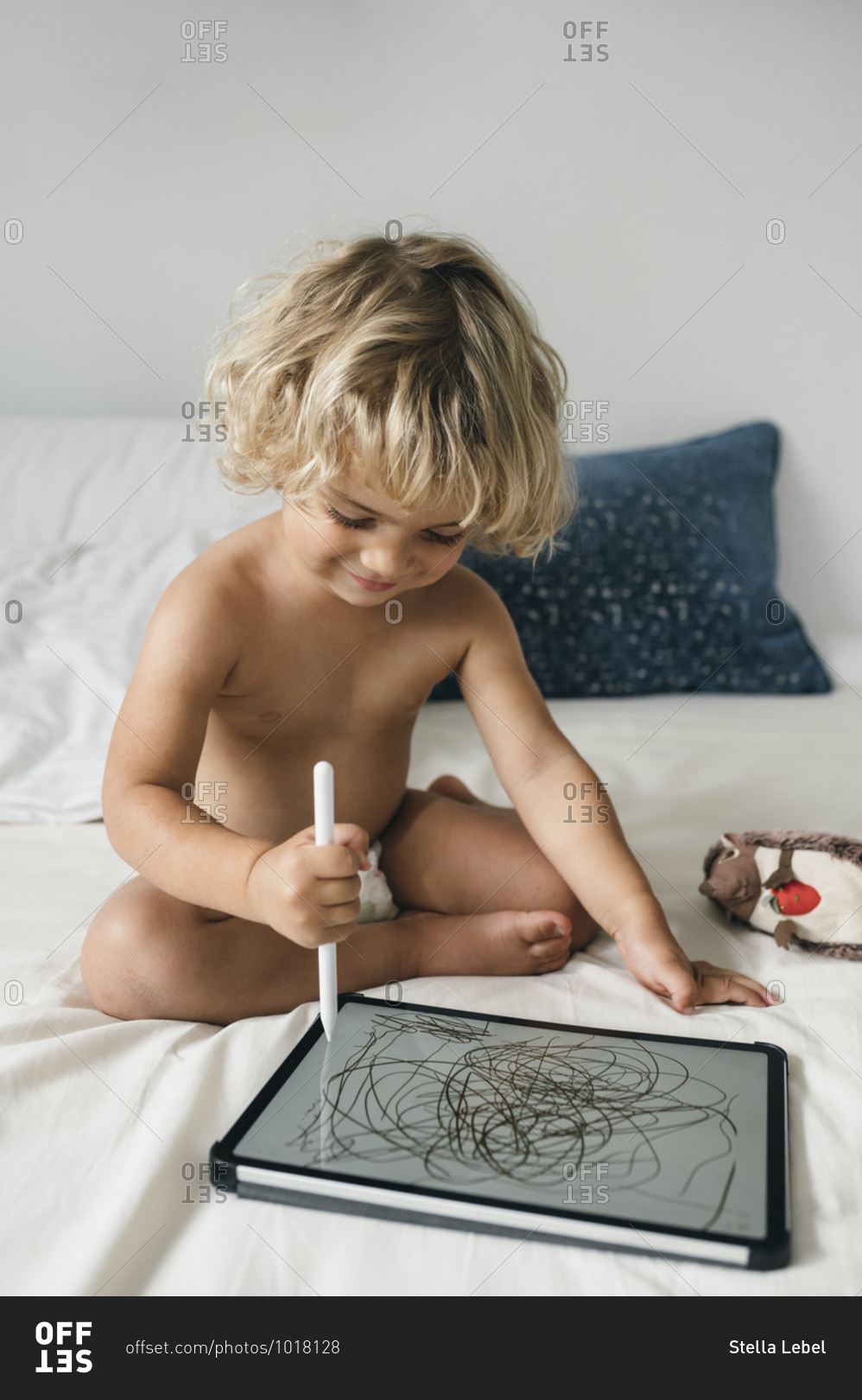 Toddler boy doodling on tablet