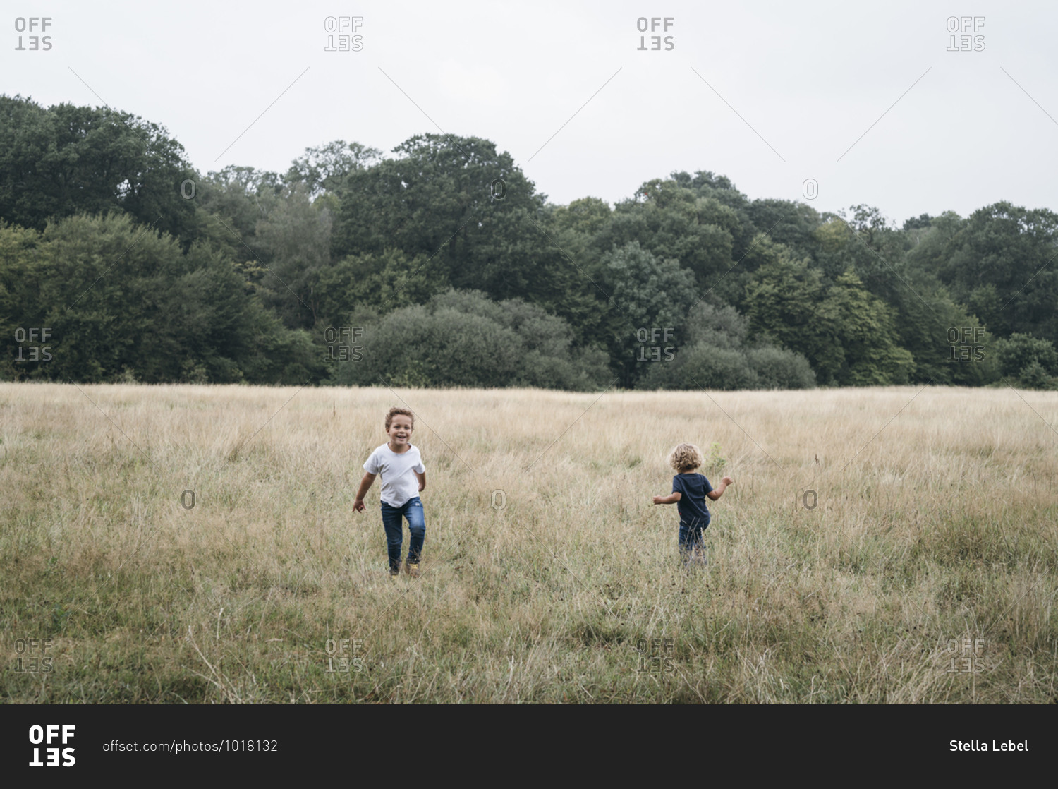 Two brothers playing in empty field