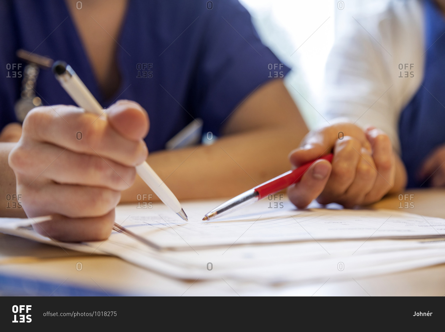 Nurses hands checking medical record