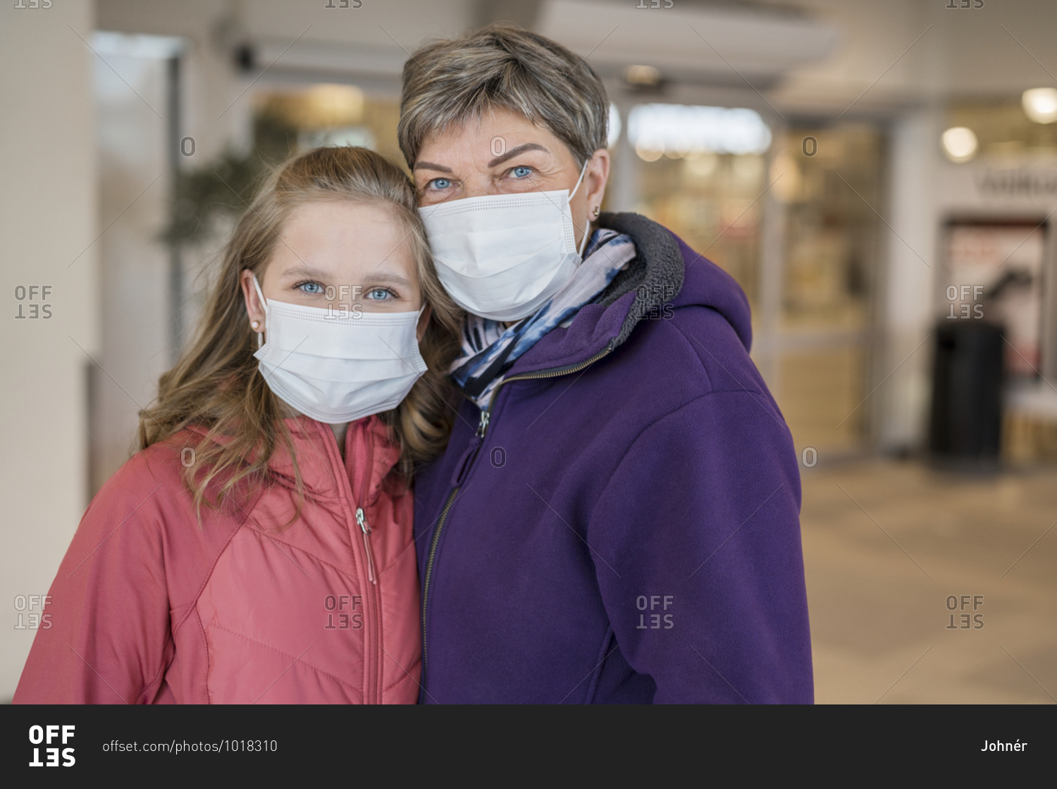 Mother and daughter wearing protective masks