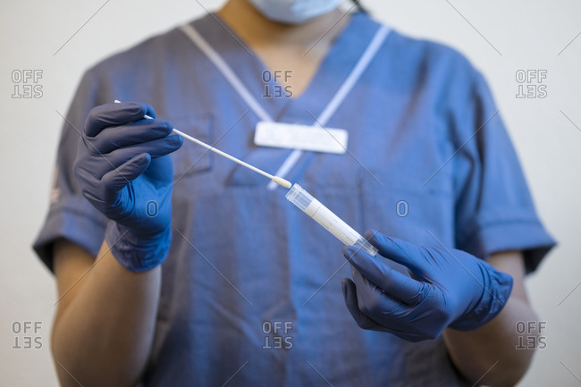 Scientist examining medical sample in test tube