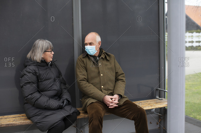 Man and woman waiting for public transportation