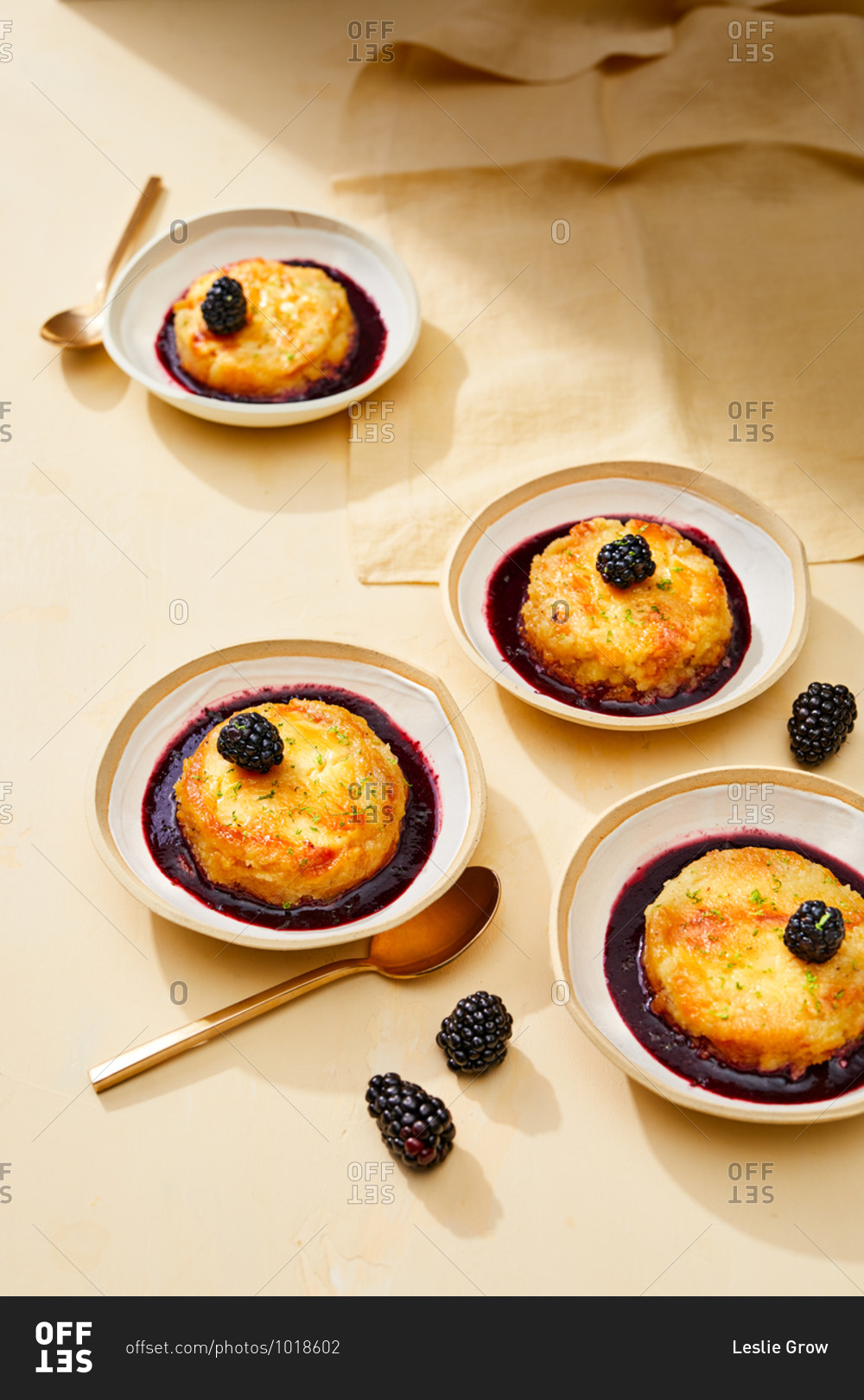 Mini custard cakes topped with blackberries
