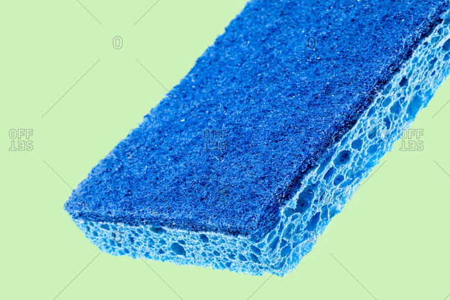 Blue sponge on light green background