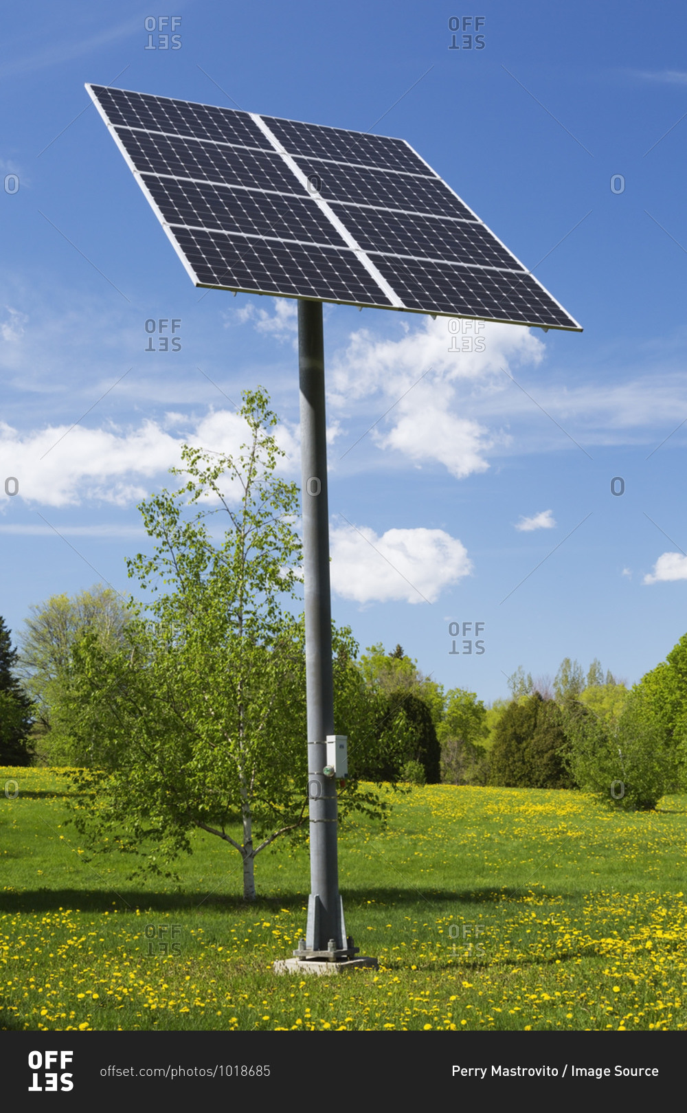 Solar energy collector panels mounted on metal post in field, Quebec, Canada