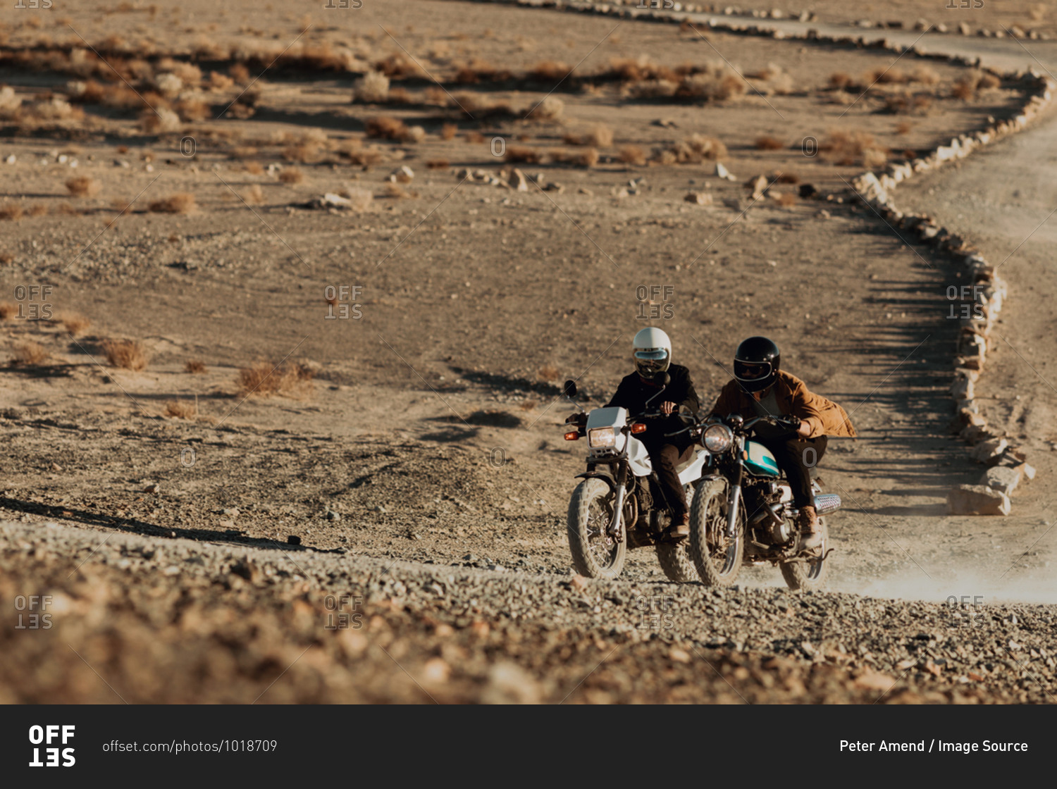 Motorcyclist friends riding in desert, Trona Pinnacles, California, US
