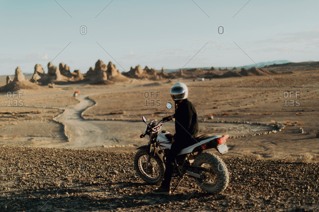 Motorcyclist on stationary bike, Trona Pinnacles, California, US