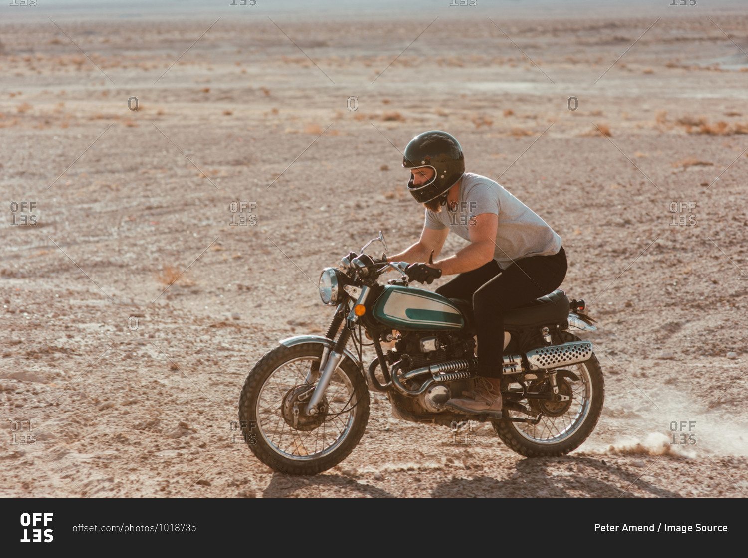 Motorcyclist riding in desert, Trona Pinnacles, California, US