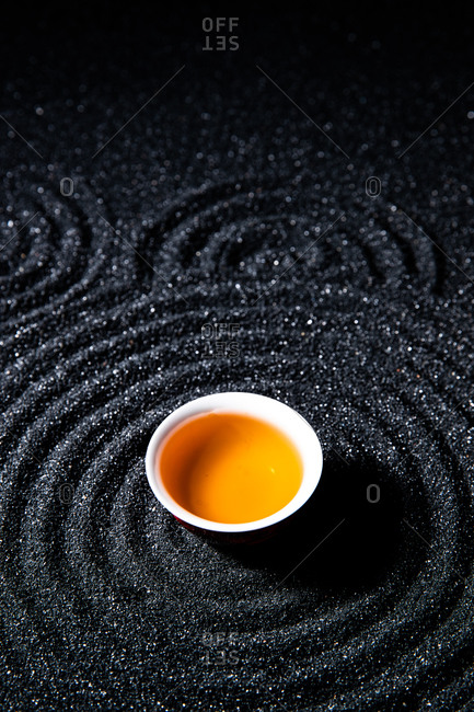 A cup of black tea on a dark table