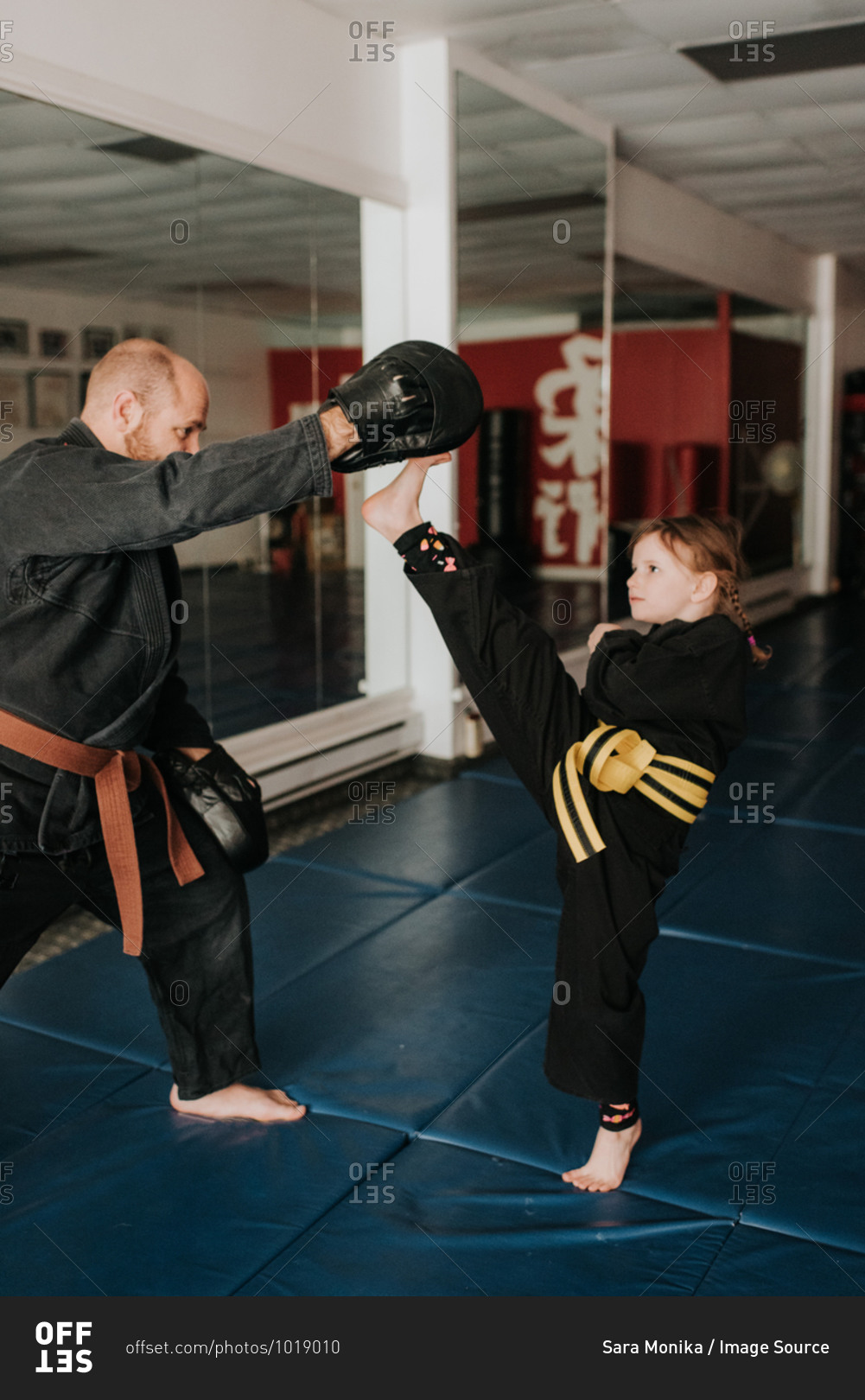 Coach and student practicing kickboxing in studio