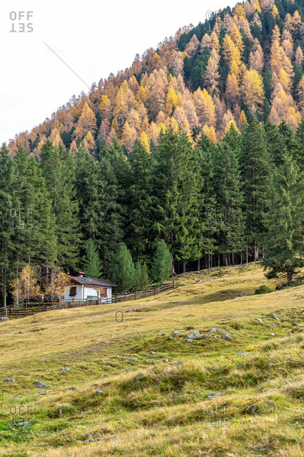 November 2, 2019: Europe, Austria, Tyrol, Stubai Alps, Sellrain, St. Sigmund im Sellrain, hunting lodge in front of the autumnal mountain forest in Sellraintal in the Stubai Alps