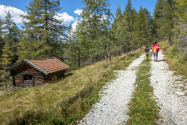 Europe, Austria, Tyrol, Stubai Alps, Neustift im Stubaital, mother and son hike to the Eulenwiesen natural setting in the Stubai
