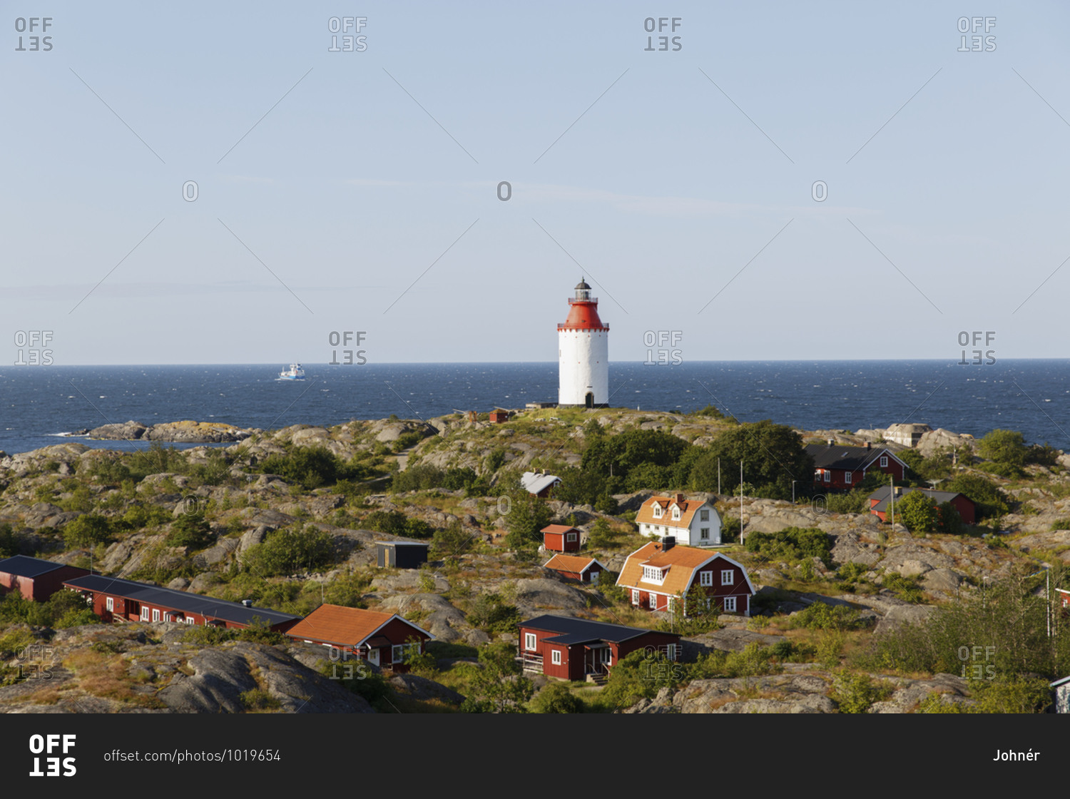 Wooden houses and lighthouse at sea
