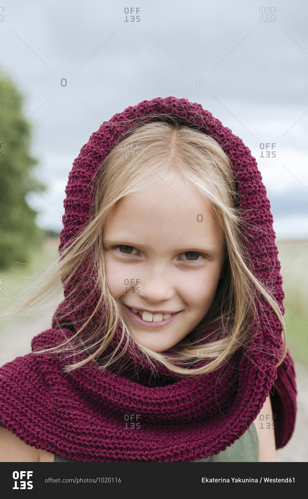 Portrait of smiling blond girl with round scarf