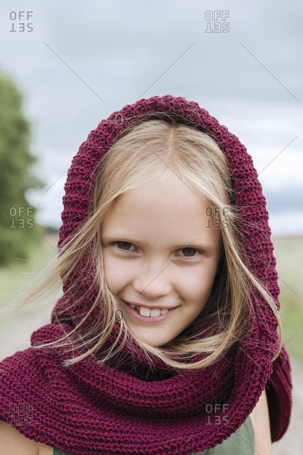 Portrait of smiling blond girl with round scarf