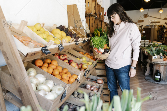 Shoppers examine fruits and vegetables sold at a local Soq