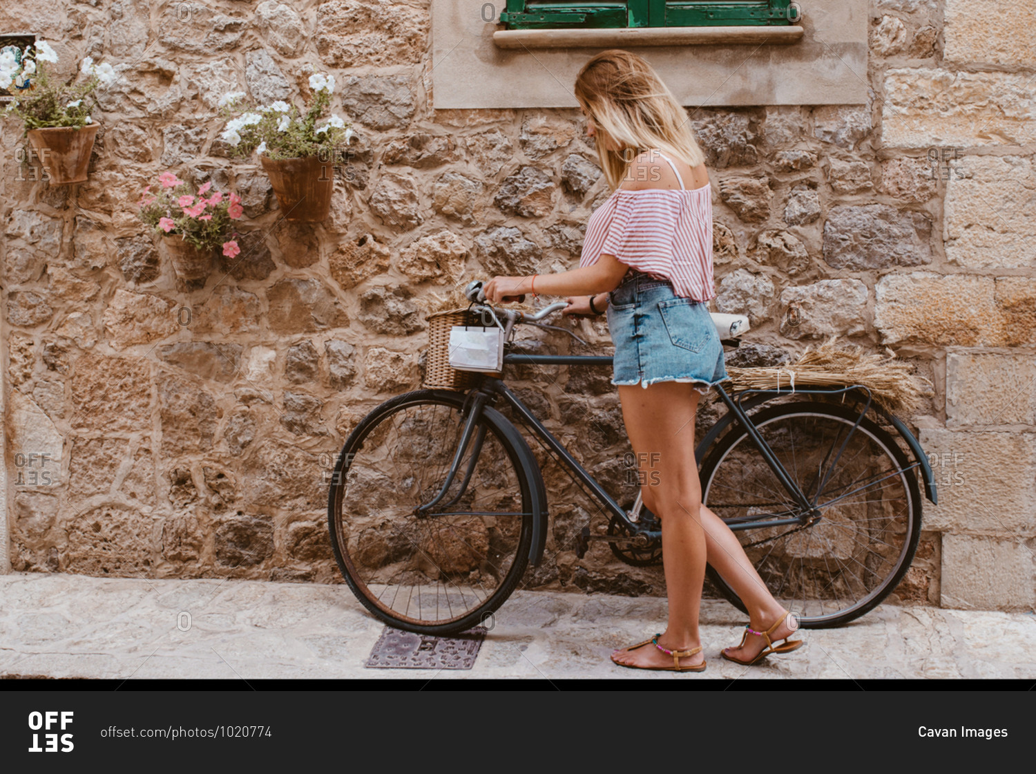 Blonde woman choosing the bike like transport in majorca