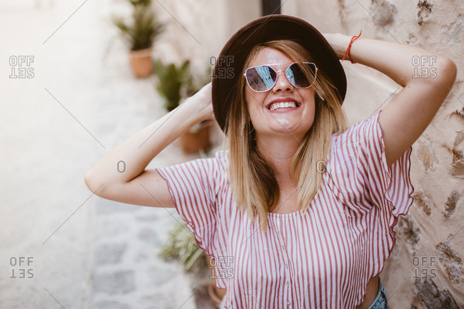 Young attractive smiling blond woman with hat joyfully