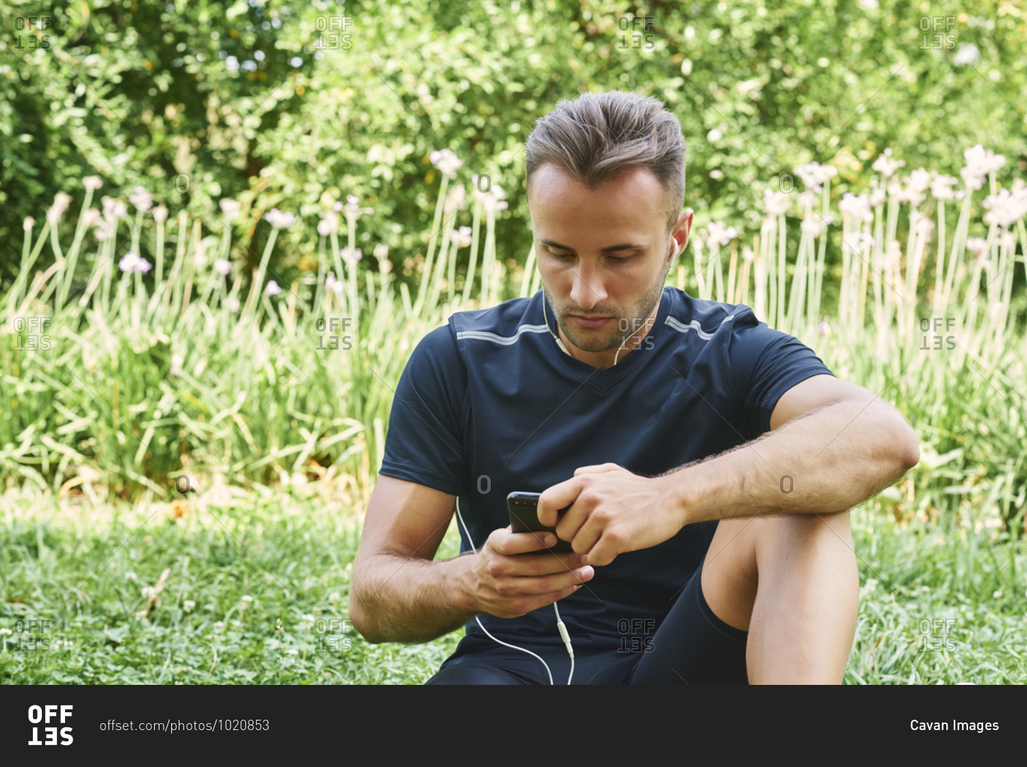 Man resting sitting on the grass in a park after training. healthy and healthy life. health and sport concept.