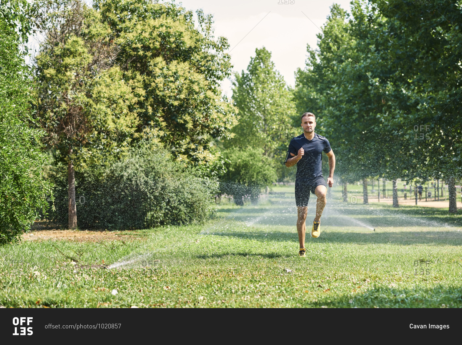 Young man training in a park, he is jogging.