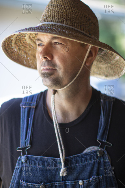 All American man with straw hat looking off camera