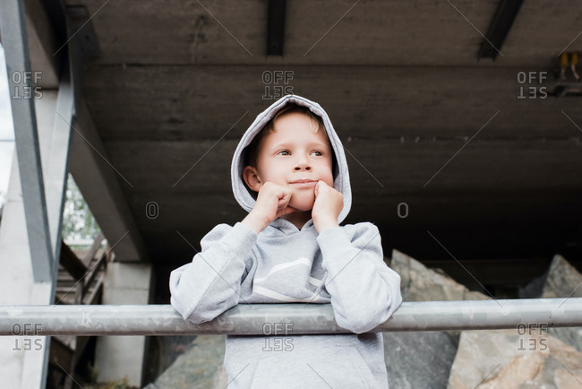 Portrait of a young boy in a sports hoody looking out over the track