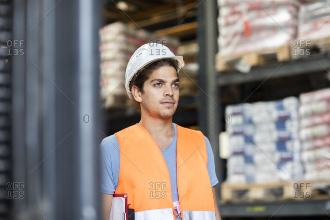 Young store worker with helmet working in a store
