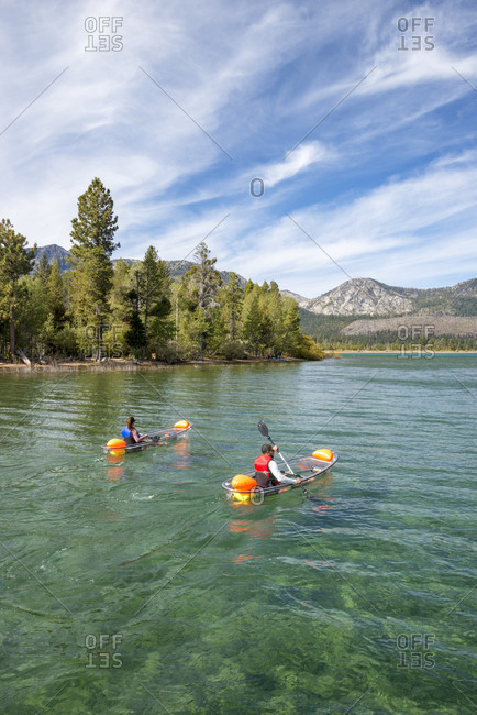 A man and woman kayaking on lake tahoe, ca