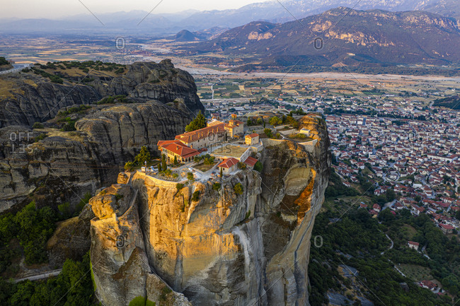 Aerial by drone of the Holy Monastery of Holy Trinity at sunrise, UNESCO World Heritage Site, Meteora Monasteries, Greece, Europe