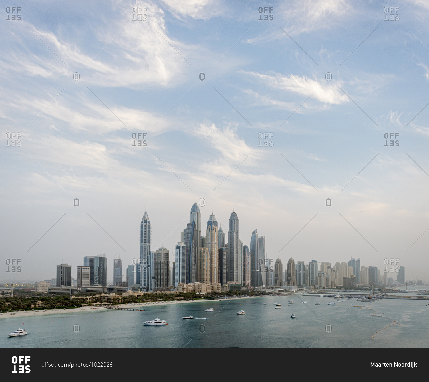 Skyscrapers in the downtown skyline and boats in the harbor, Dubai, United Arab Emirates