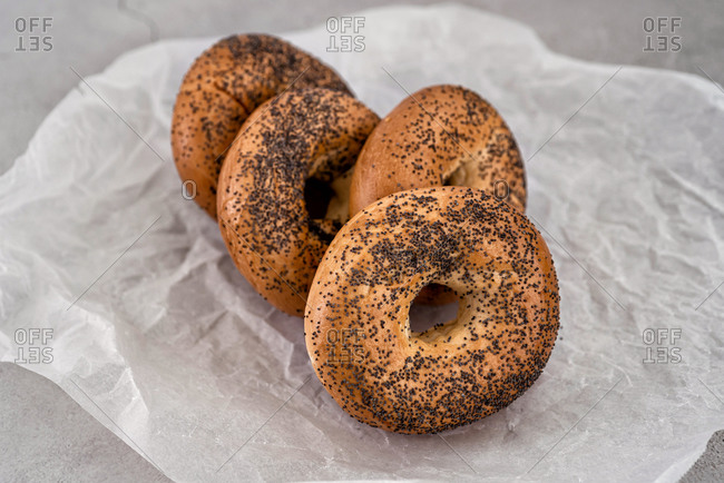 Bagels stacked on a waxed paper