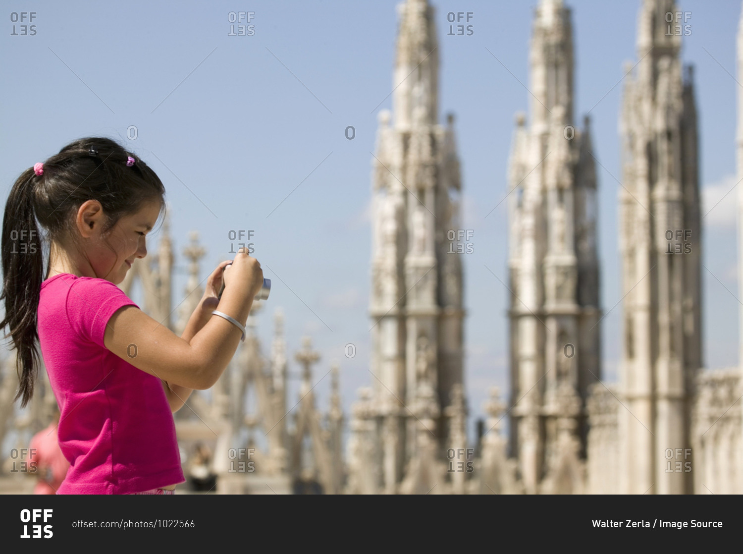 Girl photographing Milan cathedral, Milan, Lombardy, Italy