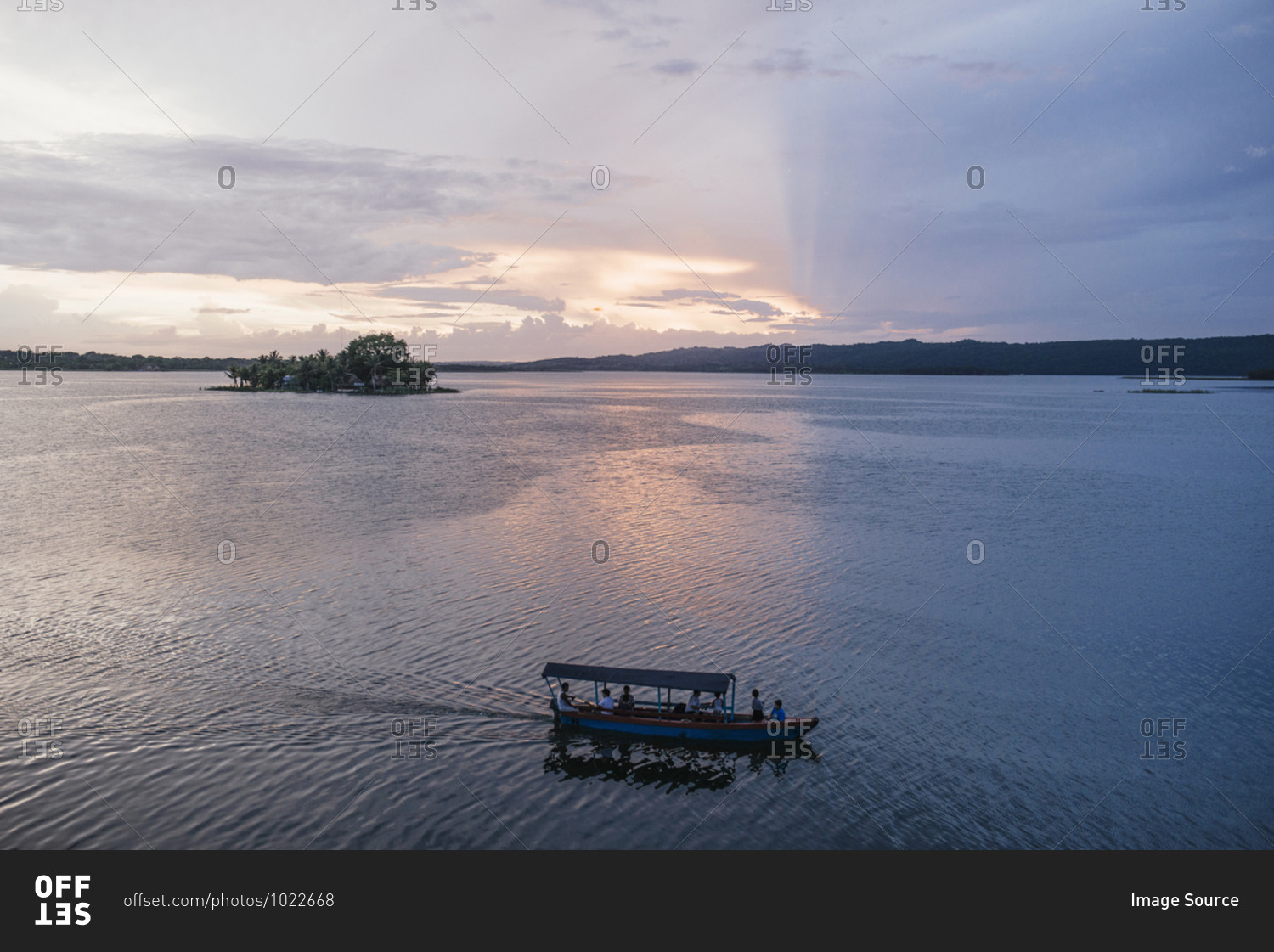 Water taxi on lake at sunset, Flores, Guatemala, Central America