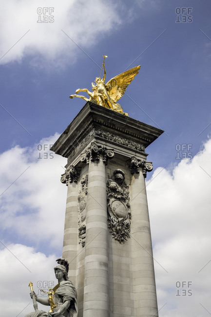 Low angle view of golden statue on Pont Alexander III, Paris, France