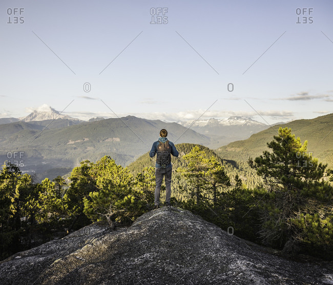 Man looking at view, Stawamus Chief, overlooking Howe Sound Bay, Squamish, British Columbia, Canada