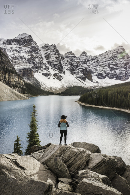 Woman standing, looking at view, Moraine Lake, Lake Louise, Alberta, Canada