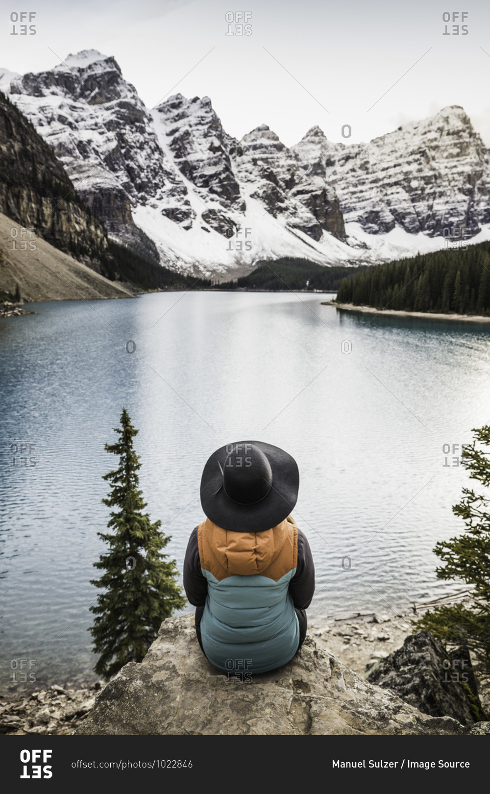 Woman sitting, looking at view, Moraine Lake, Lake Louise, Alberta, Canada