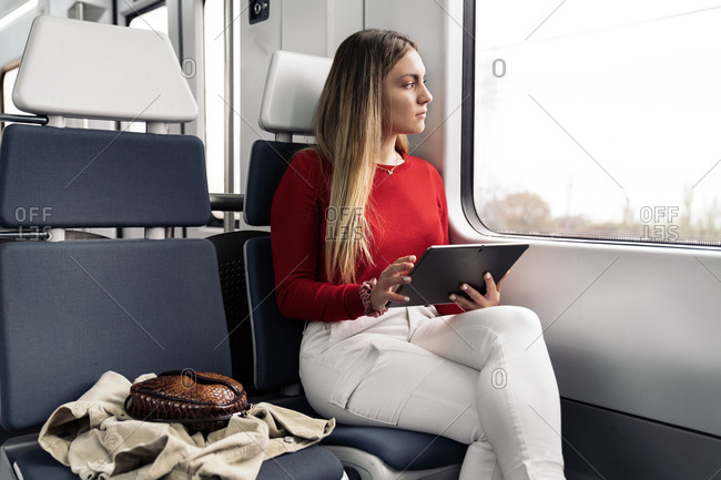 Young attractive woman using a tablet during her journey