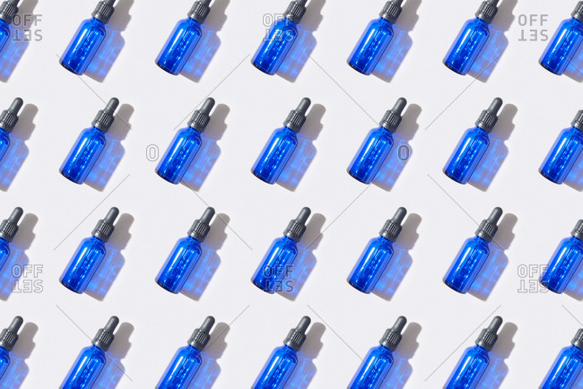 Horizontal pattern from blue bottles with cbd oil.