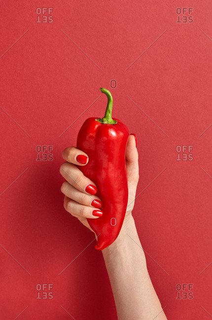 Sweet red paprika vegetables in the woman's hand.