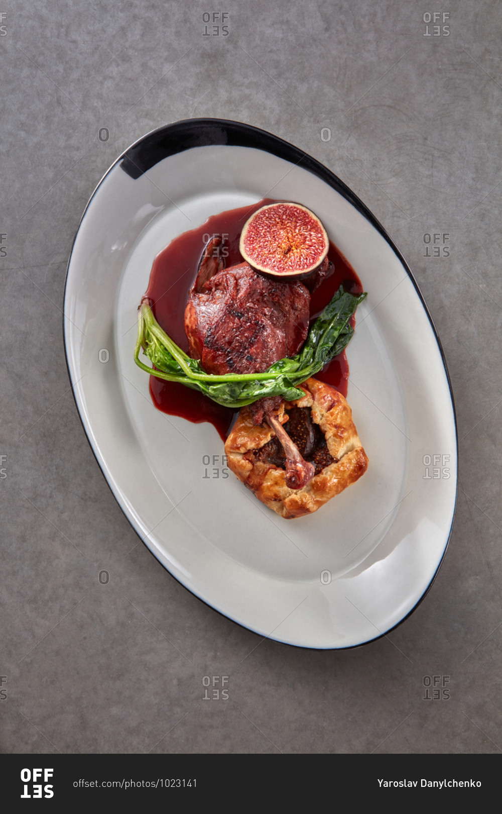 Freshly cooked natural duck leg with fig pie and sauce.